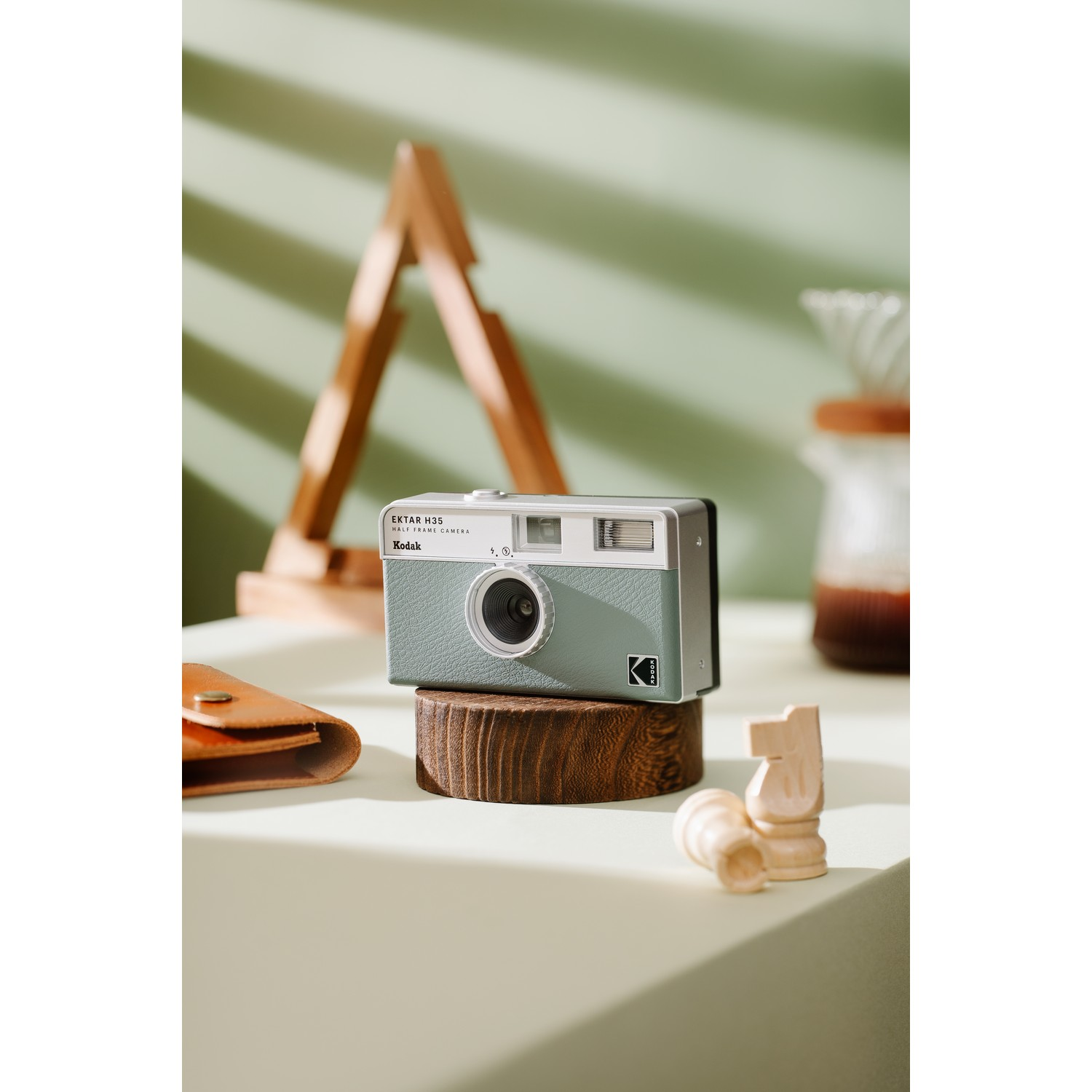 A retro style camera in a mint green color.