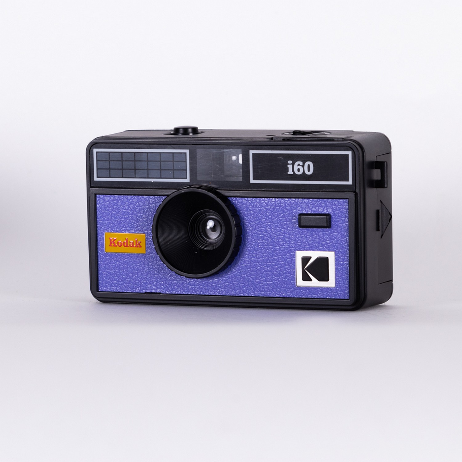 Kodak i60 camera, black body with purple textured front and Kodak logo. White background.