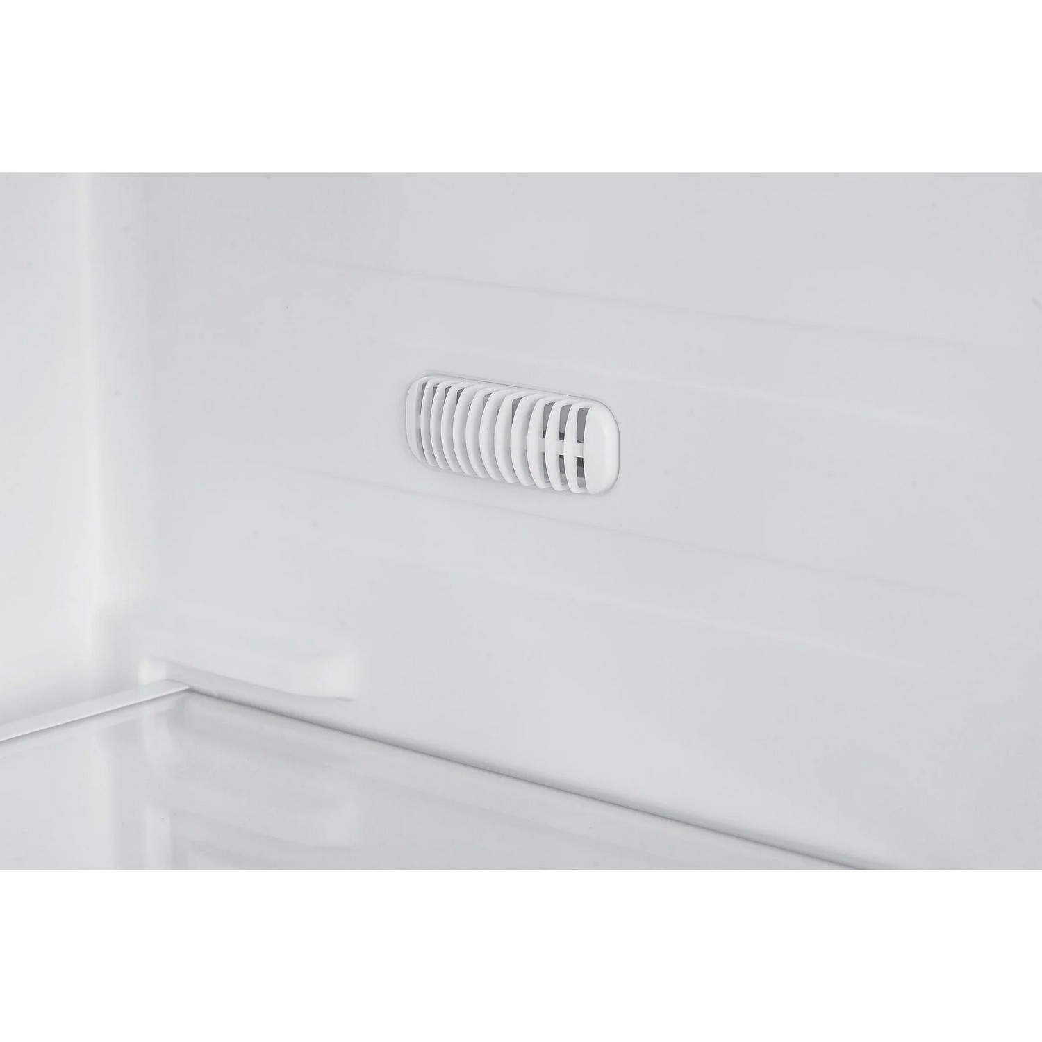 White refrigerator interior with a vent and a shelf visible.