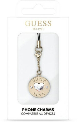 Zawieszka do telefonu Guess w białym pudełku. Zawieszka ma kryształ w kształcie serca i słowo LOVE.