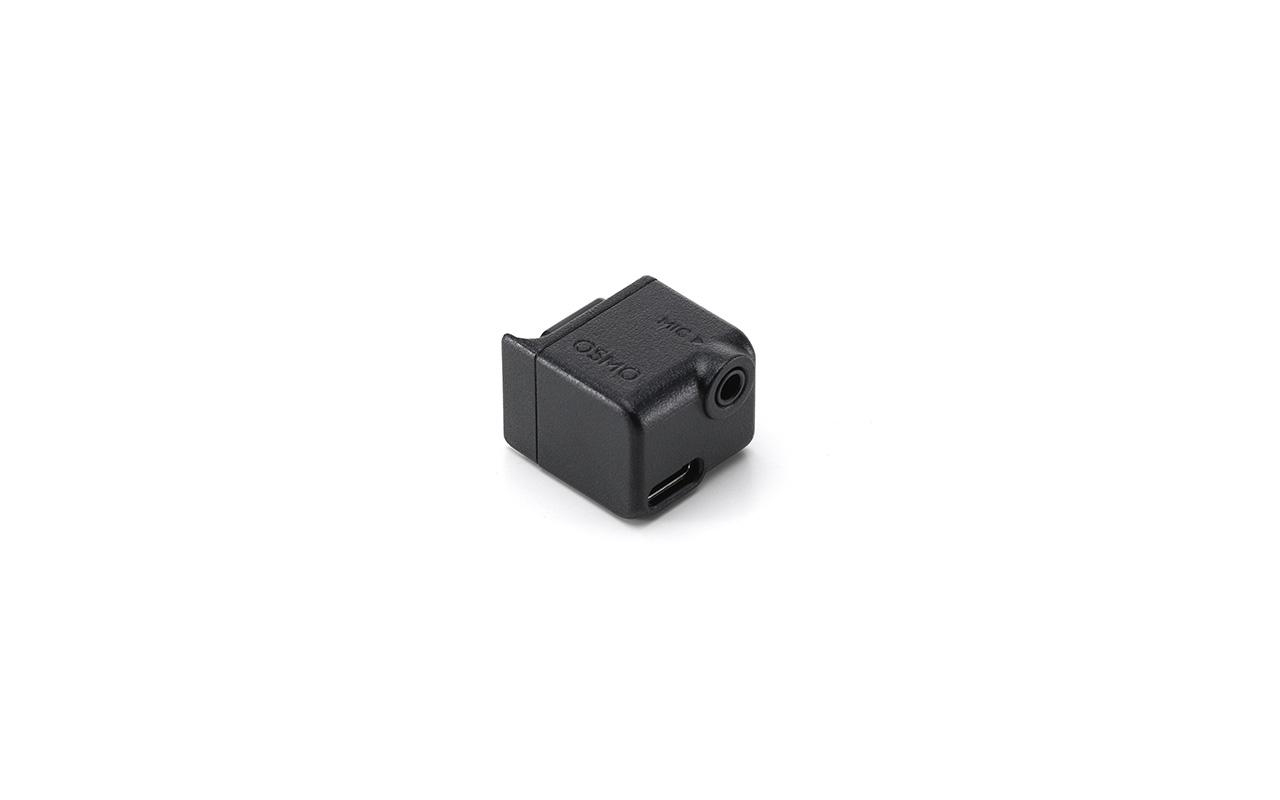 Schwarzer Osmo Mikrofonadapter auf weißem Hintergrund, mit Mikrofon- und USB-Anschluss.