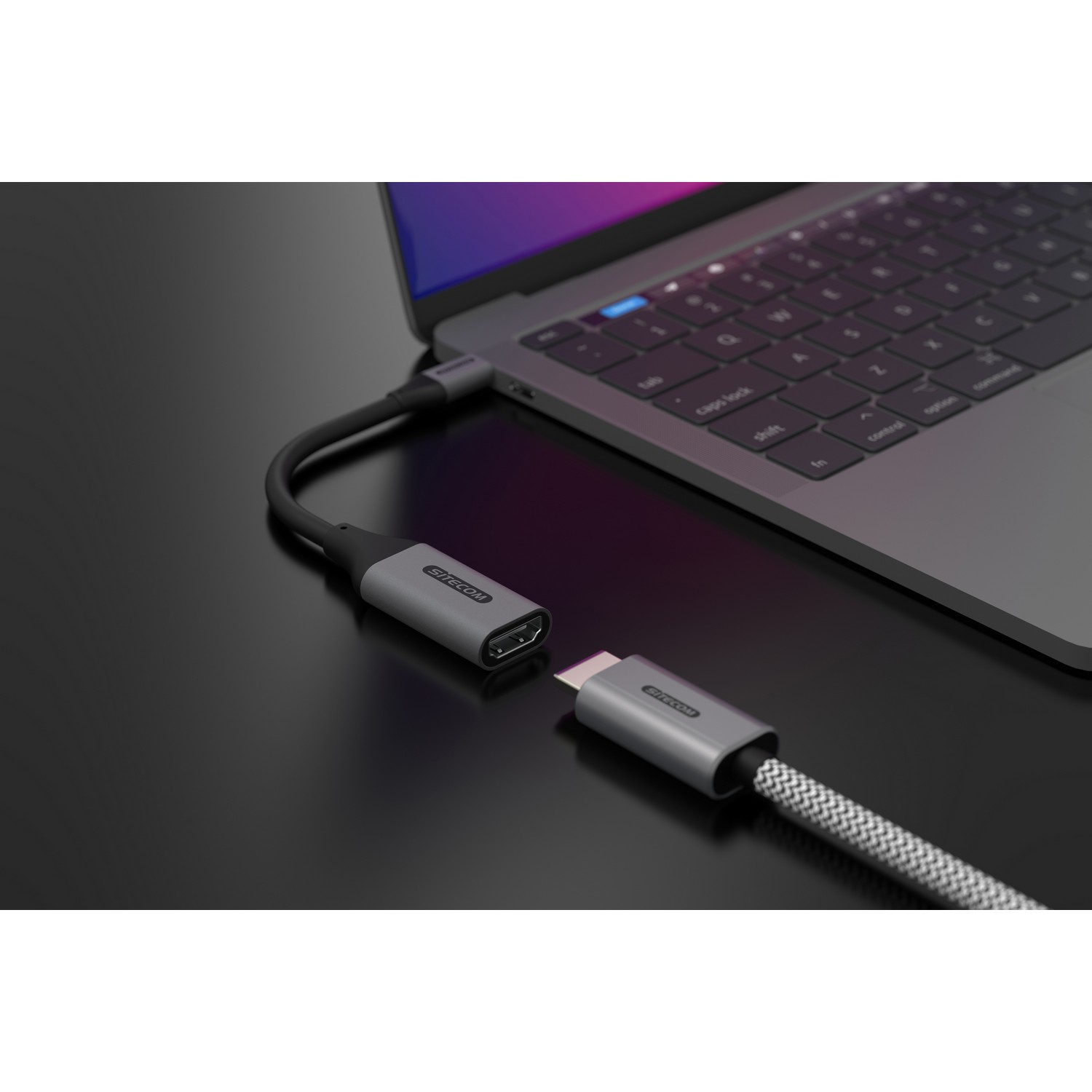 A laptop connected to an HDMI port via a USB-C adapter cable.