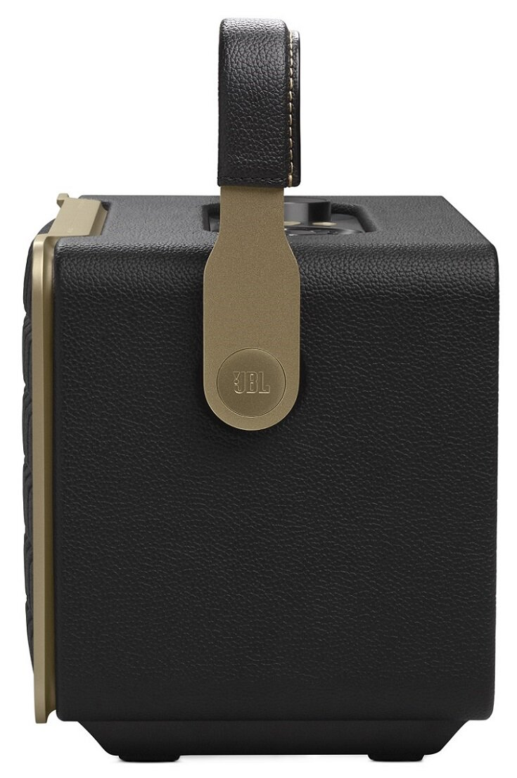 Czarny i złoty głośnik ze skórzaną rączką. Logo JBL na złotym akcencie.