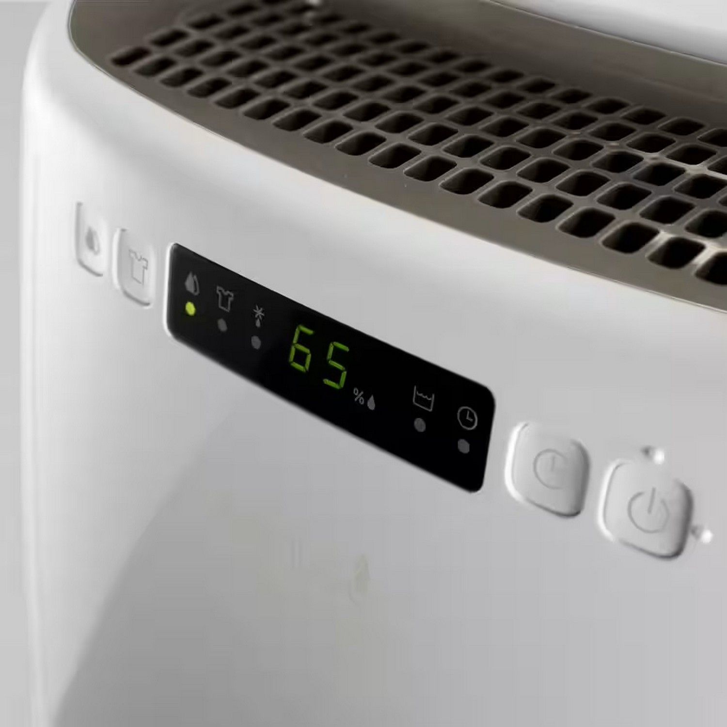 Close-up of a white dehumidifier's control panel showing the humidity level and power buttons.
