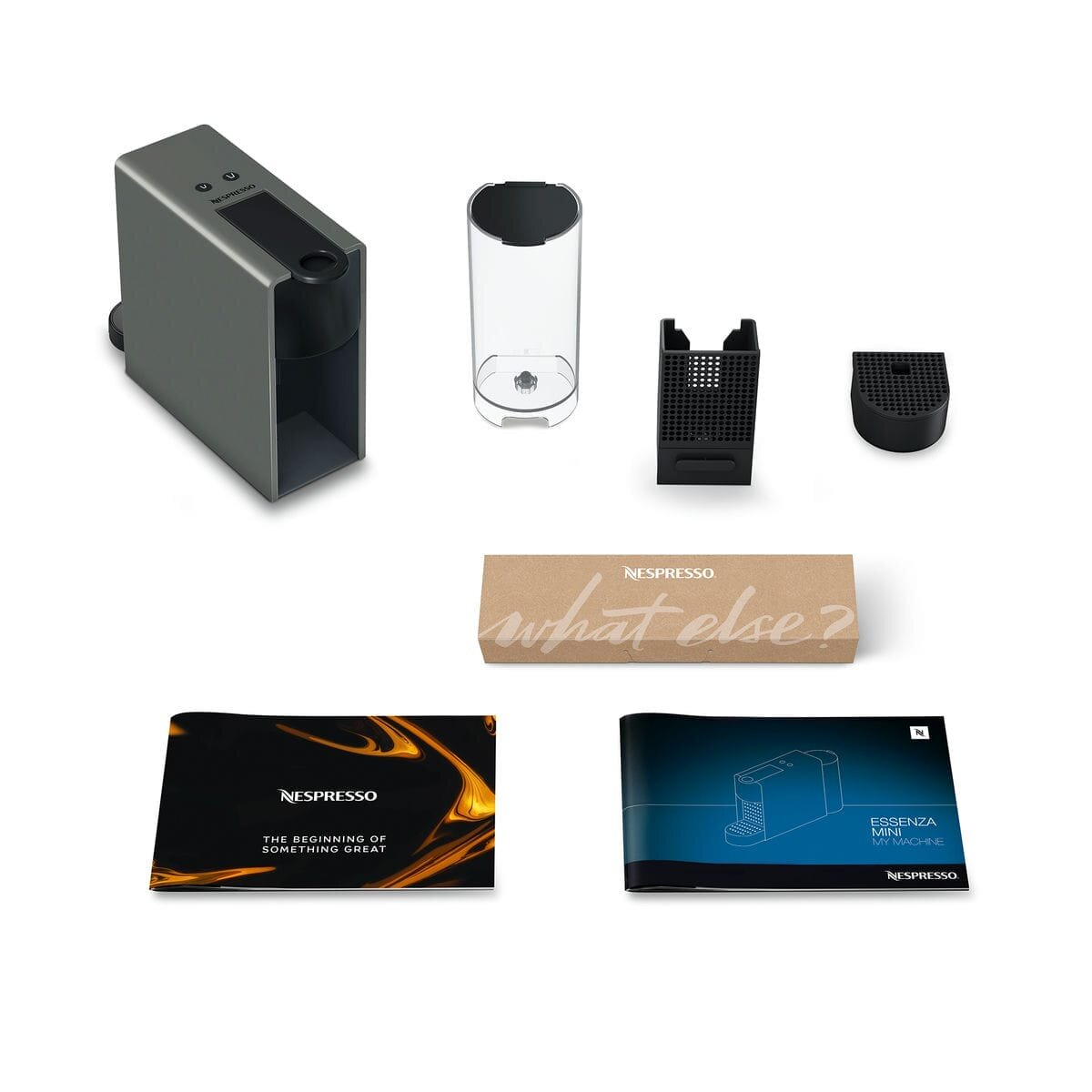 Ekspres do kawy Nespresso Essenza Mini i akcesoria, w tym pudełko, instrukcje i zbiornik na wodę.