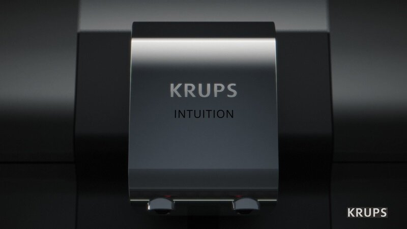 Zbliżenie czarnego ekspresu do kawy Krups Intuition. Widoczna nazwa.