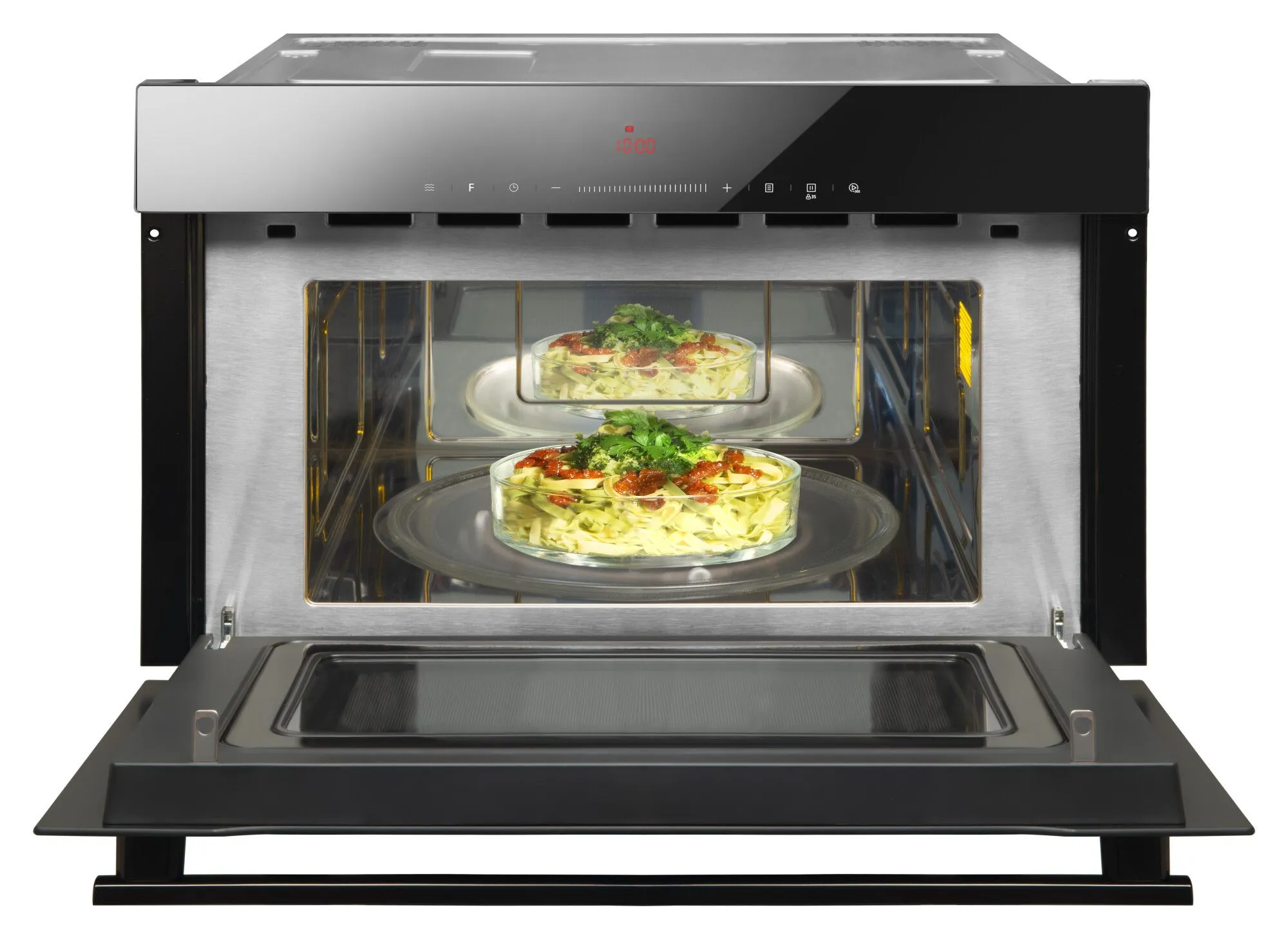 Kuchenka mikrofalowa z otwartymi drzwiami, widok z wnętrza na dwie szklane miski z jedzeniem.