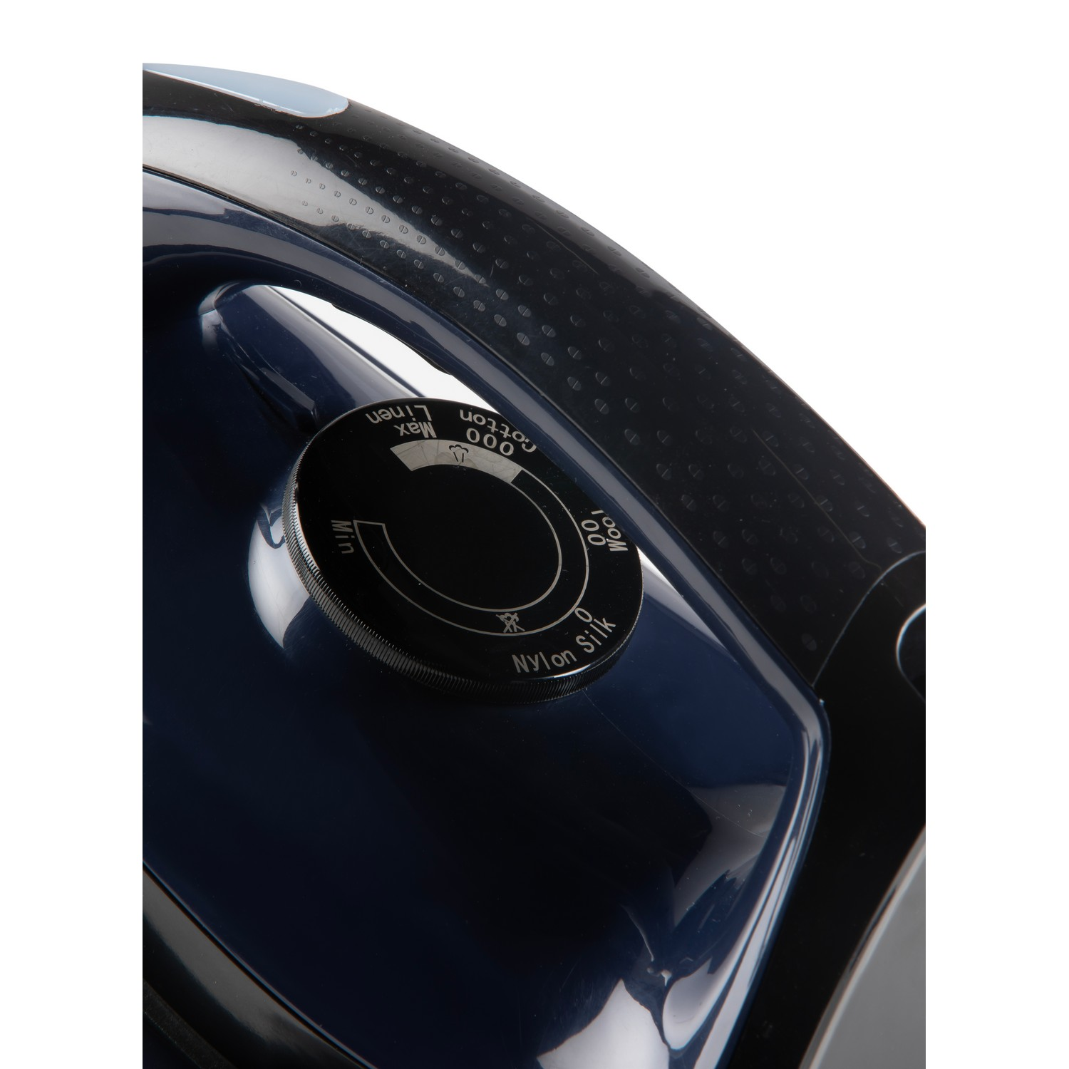 Close-up of an iron's temperature dial, showing settings for different fabric types.