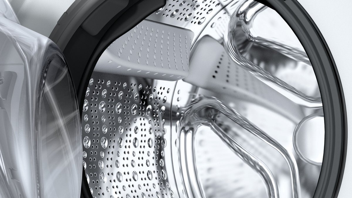 Close-up of a washing machine drum interior with water droplets.