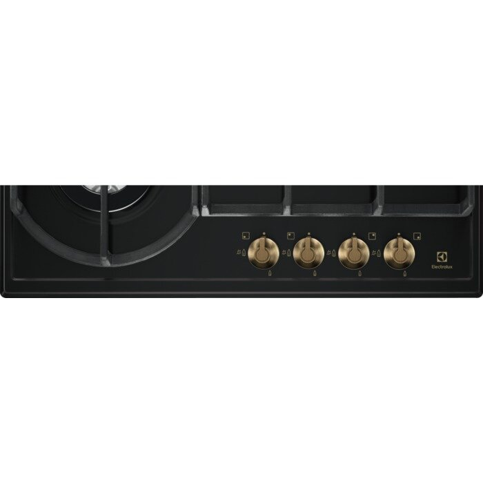 Zbliżenie na czarną płytę gazową ze złotymi pokrętłami. Widoczne są cztery pokrętła.