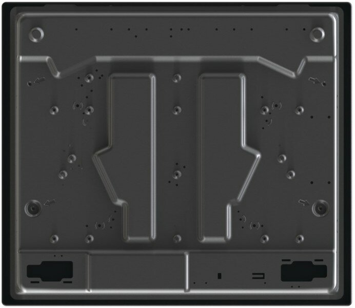 Zbliżenie, widok z góry na ciemnoszarą metalową powierzchnię z różnymi otworami i rowkami, prawdopodobnie spód urządzenia.