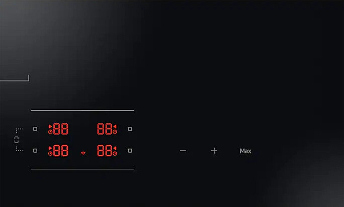 Zbliżenie płyty grzewczej z czarnymi pokrętłami, czerwonymi oznaczeniami i rusztami palników.