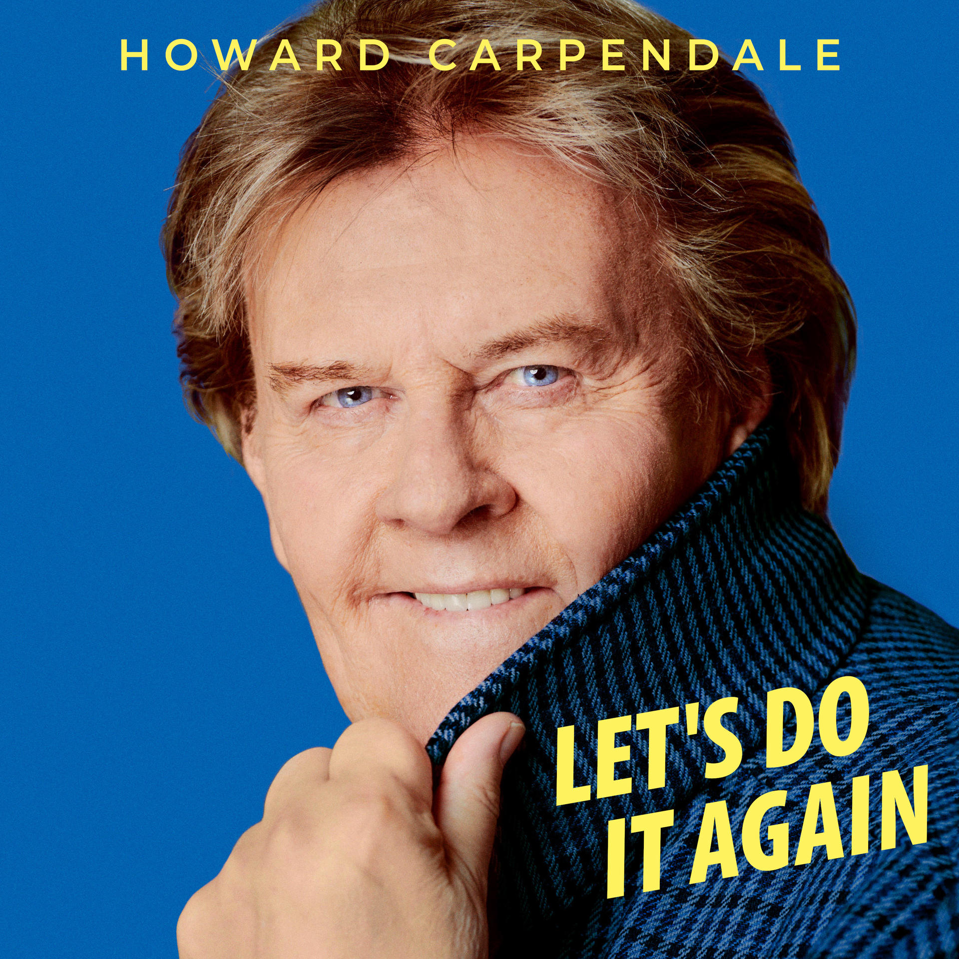 Nahaufnahme von Howard Carpendale in einer blauen Jacke mit dem Text 'LET'S DO IT AGAIN'.