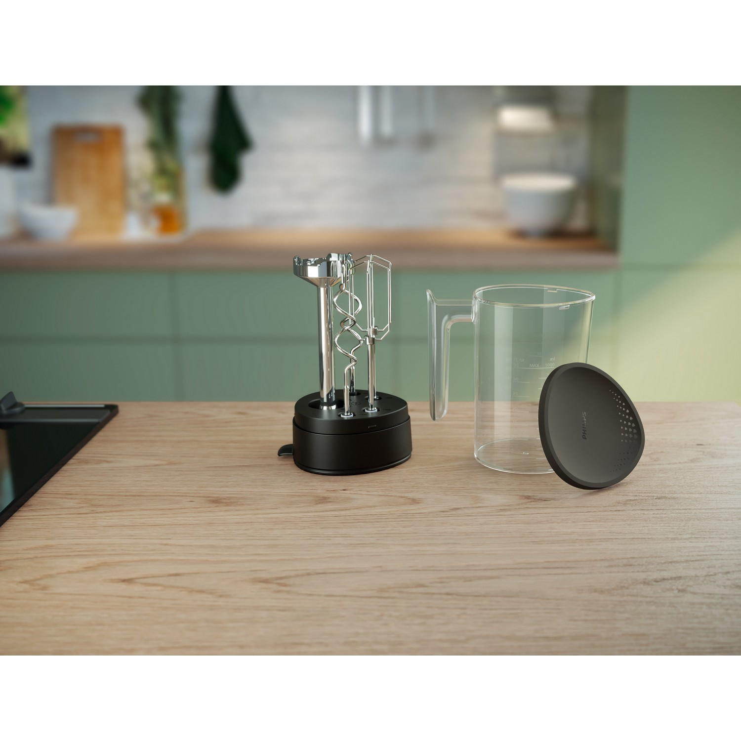Kitchen countertop with a black hand mixer base, beaters, and a clear mixing bowl.