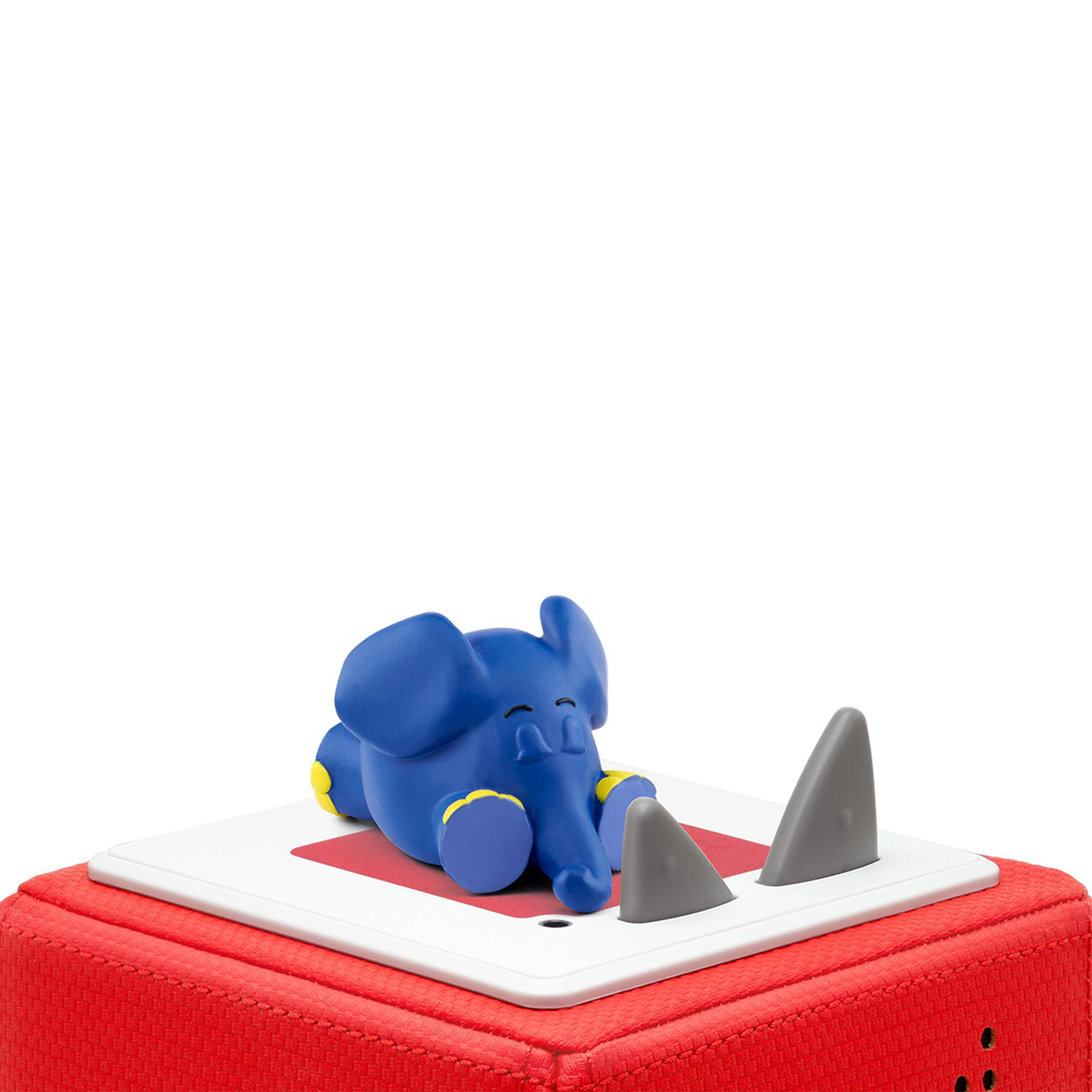 Blaues Elefanten-Spielzeug auf einer roten Box mit Haifischflossen.
