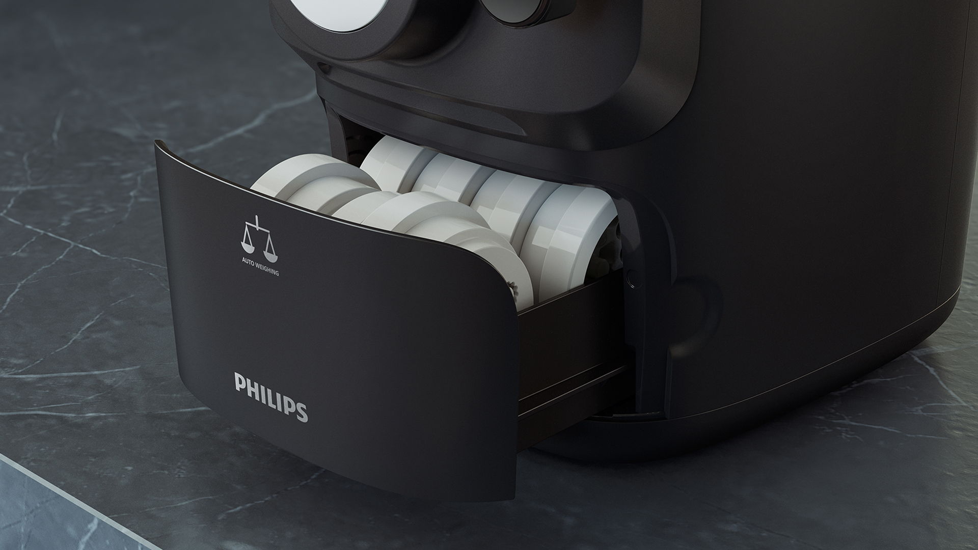 Egy fekete Philips tésztakészítő, nyitott fiókkal, amely a tésztaformákat mutatja.