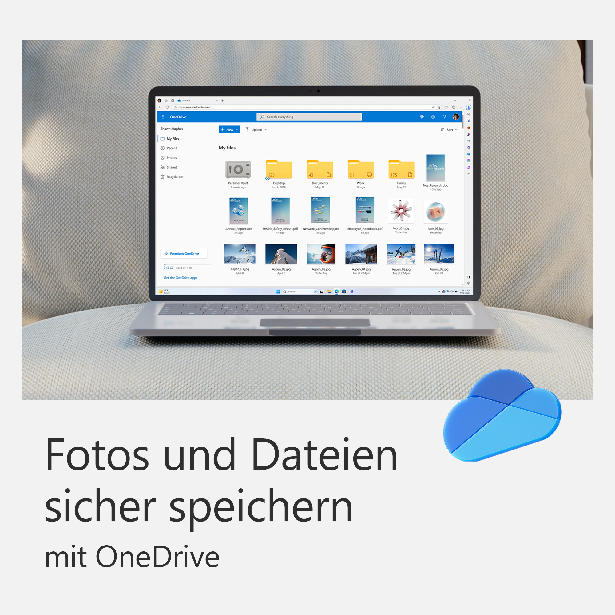 Ordinateur portable sur coussin gris clair. L'écran affiche des fichiers. Un logo de nuage bleu en bas.