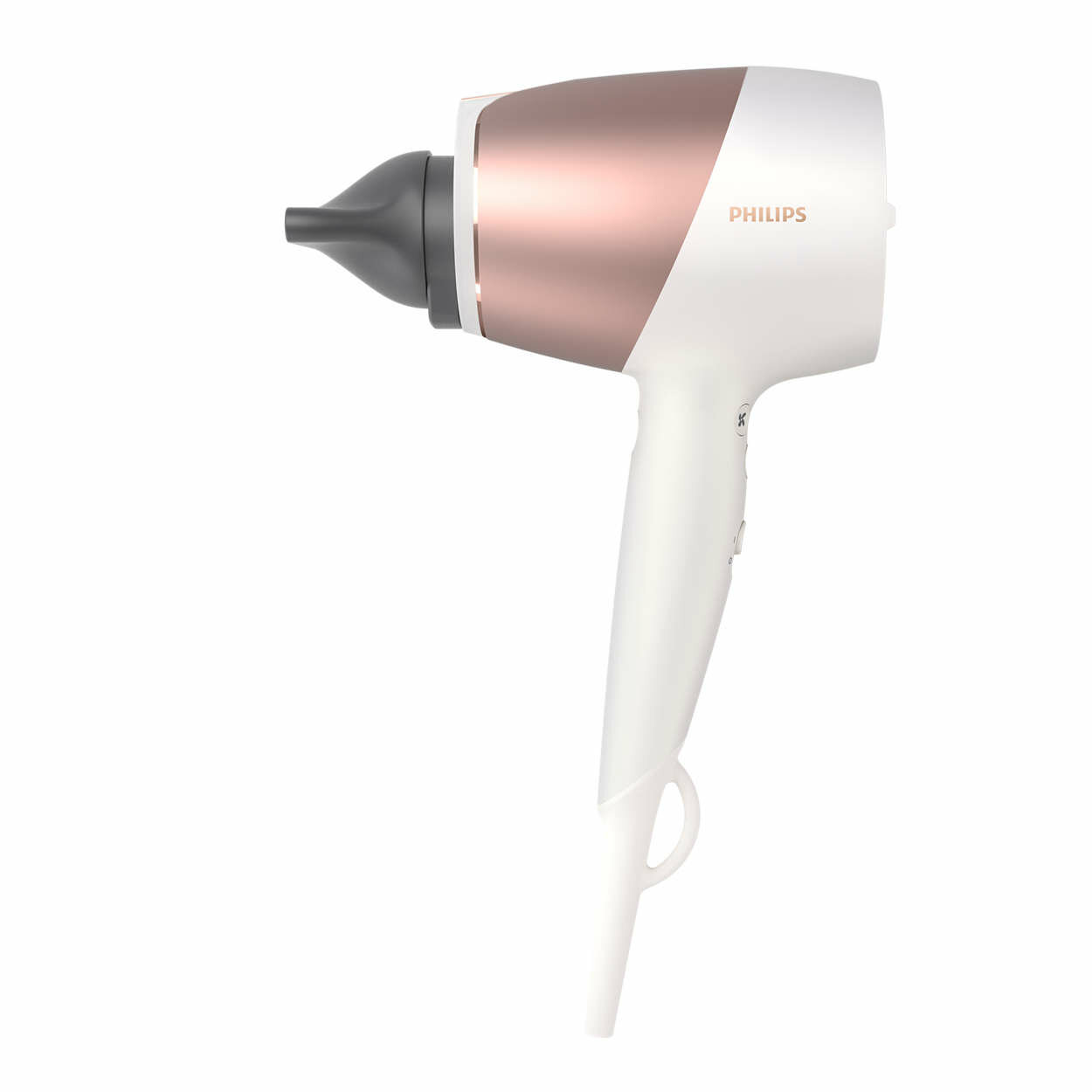 Biała i różowo-złota suszarka do włosów Philips, odizolowana na białym tle, skierowana w prawo.