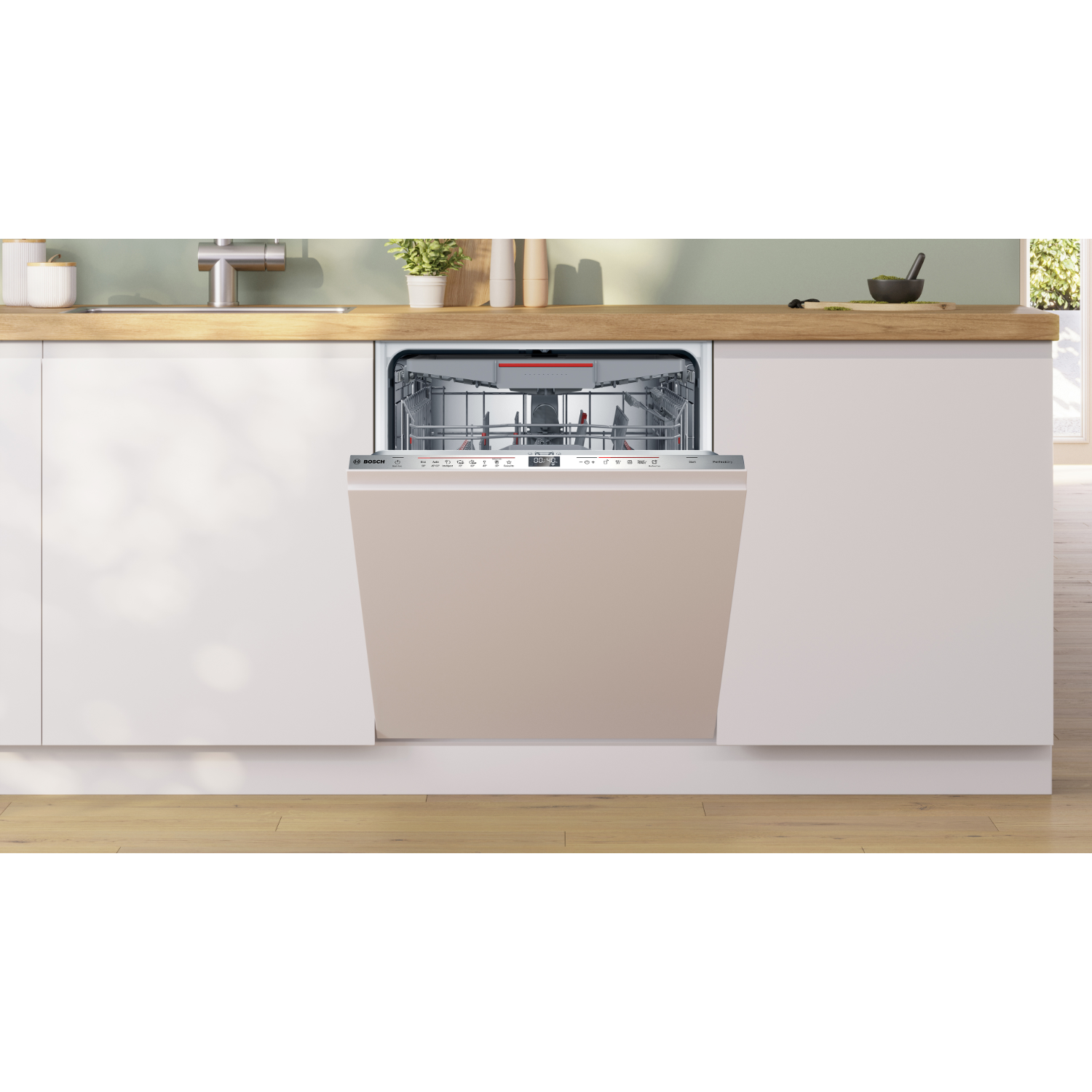 Vaatwasser met beige deur, open, interieur zichtbaar. In keuken met witte kasten en houten aanrecht.