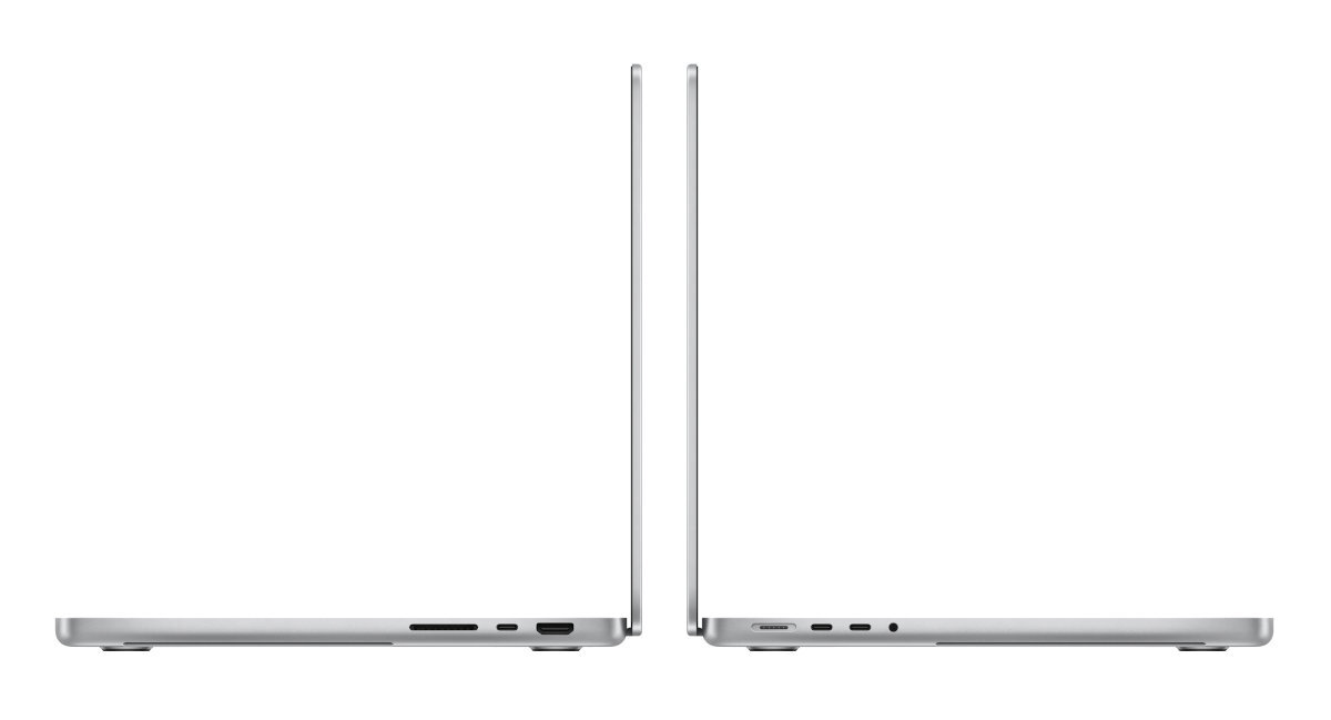 Dwa srebrne laptopy obok siebie, pokazujące swoje profile. Jeden ma porty po bokach. Oba są zamknięte.