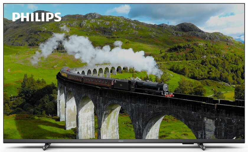 Ekran telewizora wyświetlający malowniczy krajobraz z pociągiem na moście.