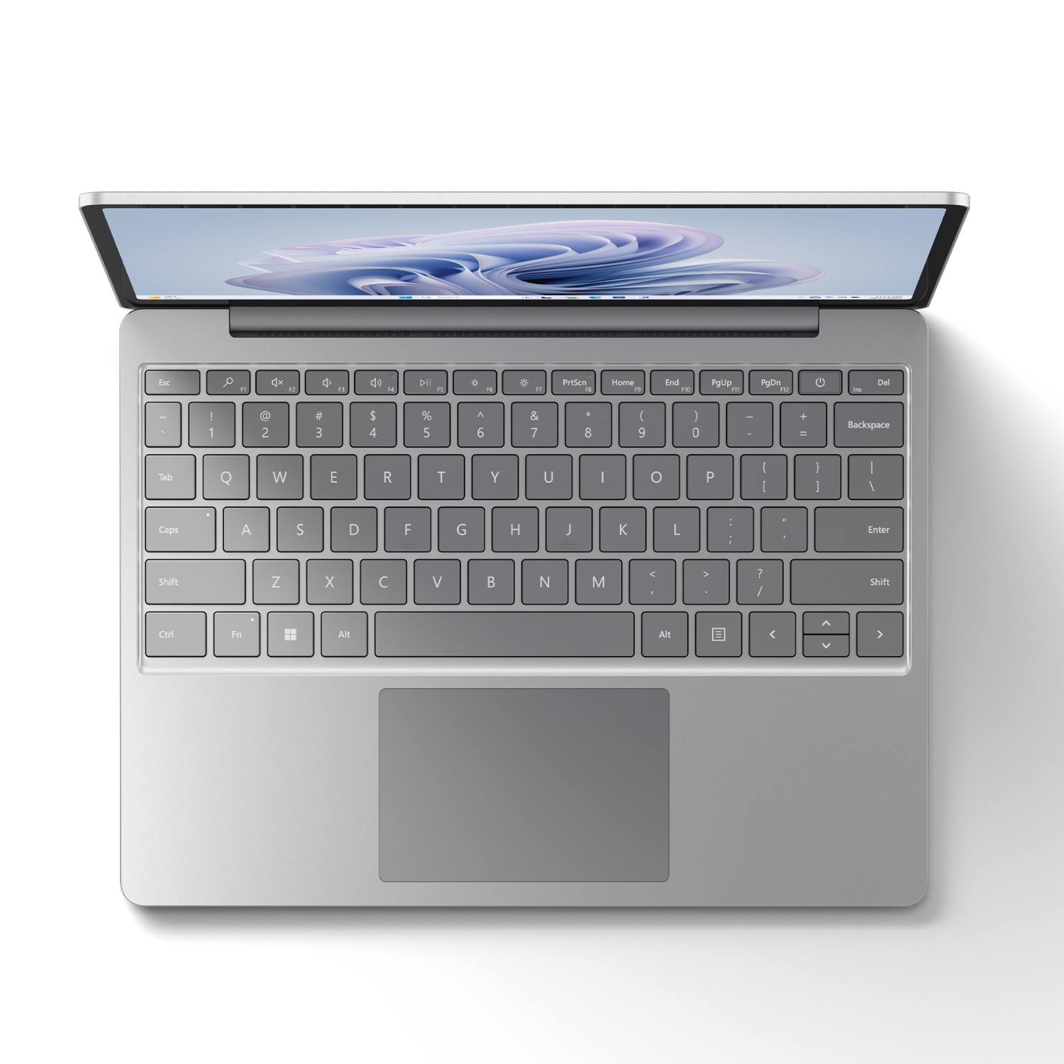 Een laptop van bovenaf. Het toetsenbord is zichtbaar en het scherm is open, met een zwarte achtergrond.
