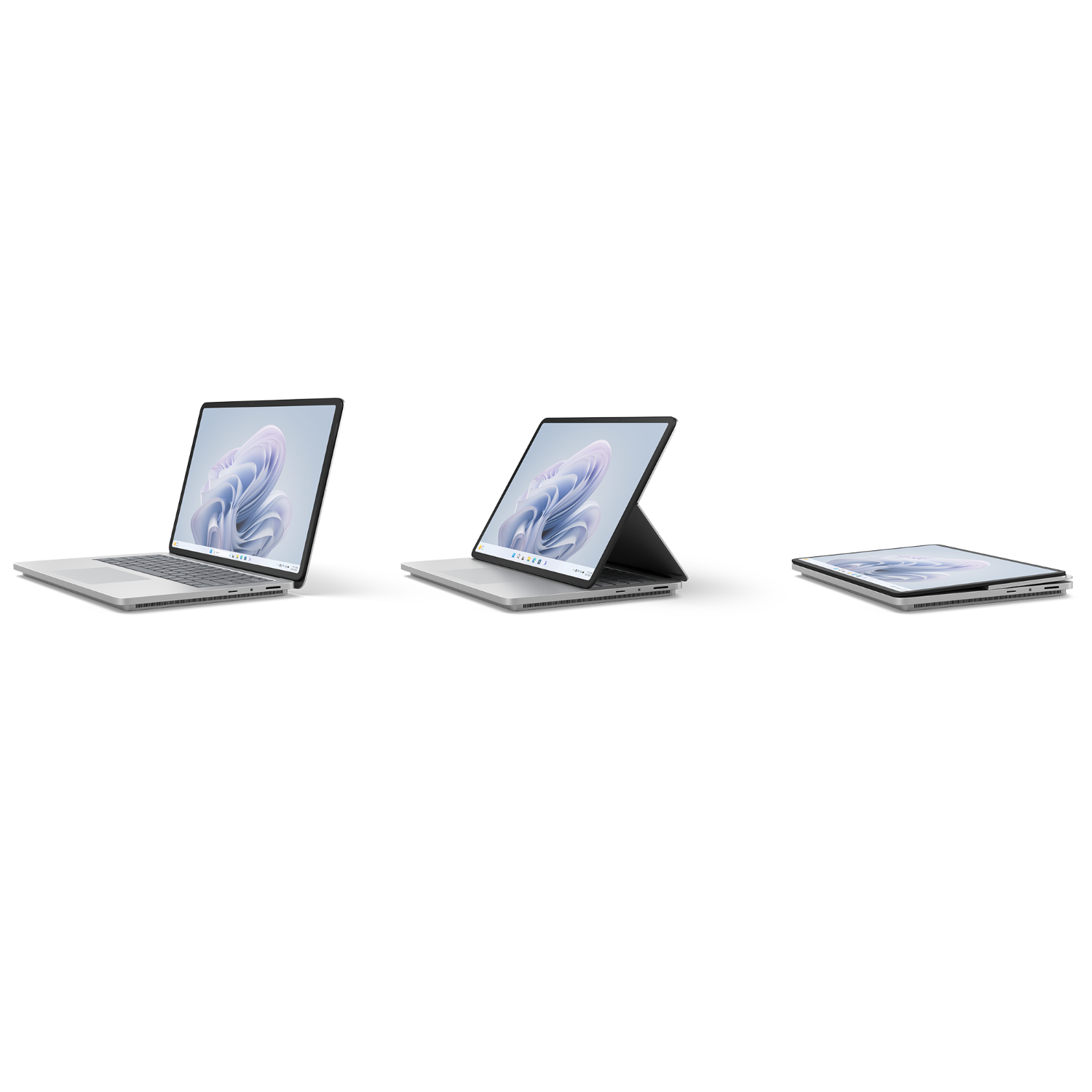 Drie laptops, verschillende openingshoeken, op een zwart oppervlak, zwarte achtergrond.