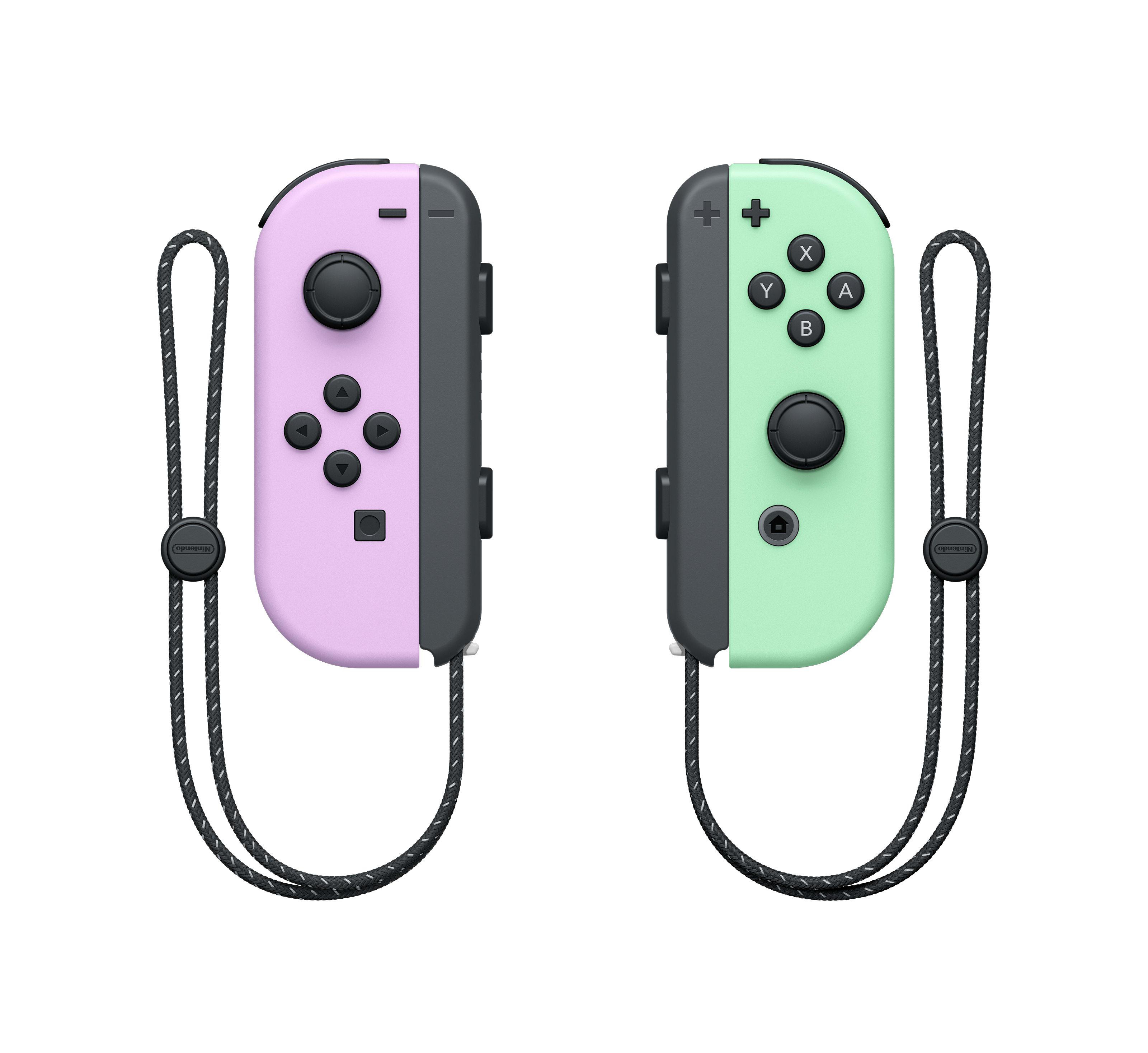 Zwei Nintendo Switch Joy-Con-Controller, einer rosa und einer grün, mit schwarzen Schlaufen und Knöpfen.