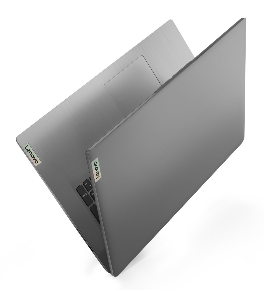 Szary laptop, częściowo otwarty, widok z góry. Widoczne logo Lenovo. Białe tło.