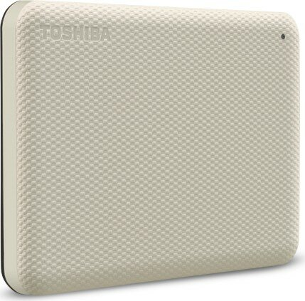 Beżowy zewnętrzny dysk twardy Toshiba, teksturowana powierzchnia, widoczna nazwa marki. Mała czarna kropka w prawym górnym rogu.