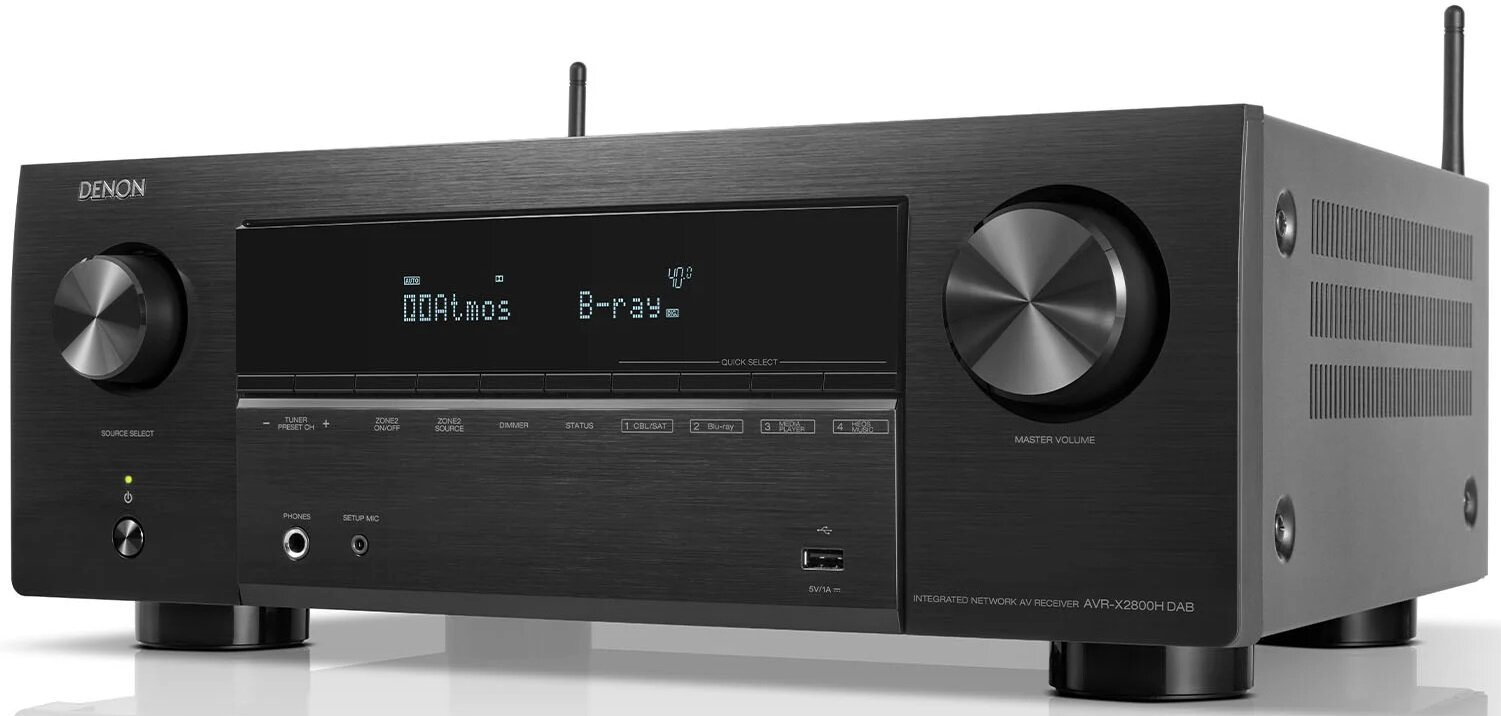Czarny amplituner AV Denon. Pokrętła, wyświetlacz z Dolby Atmos i Blu-ray. Białe tło.