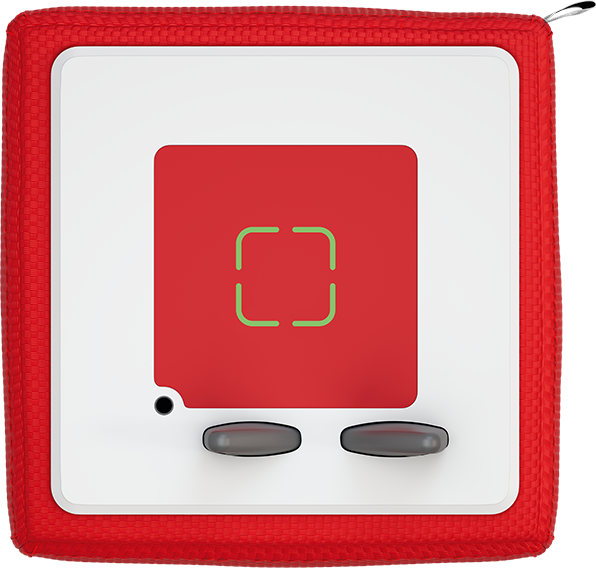 Ein rotes Würfelspielzeug mit einem roten Quadrat und einem grünen Zielsymbol.