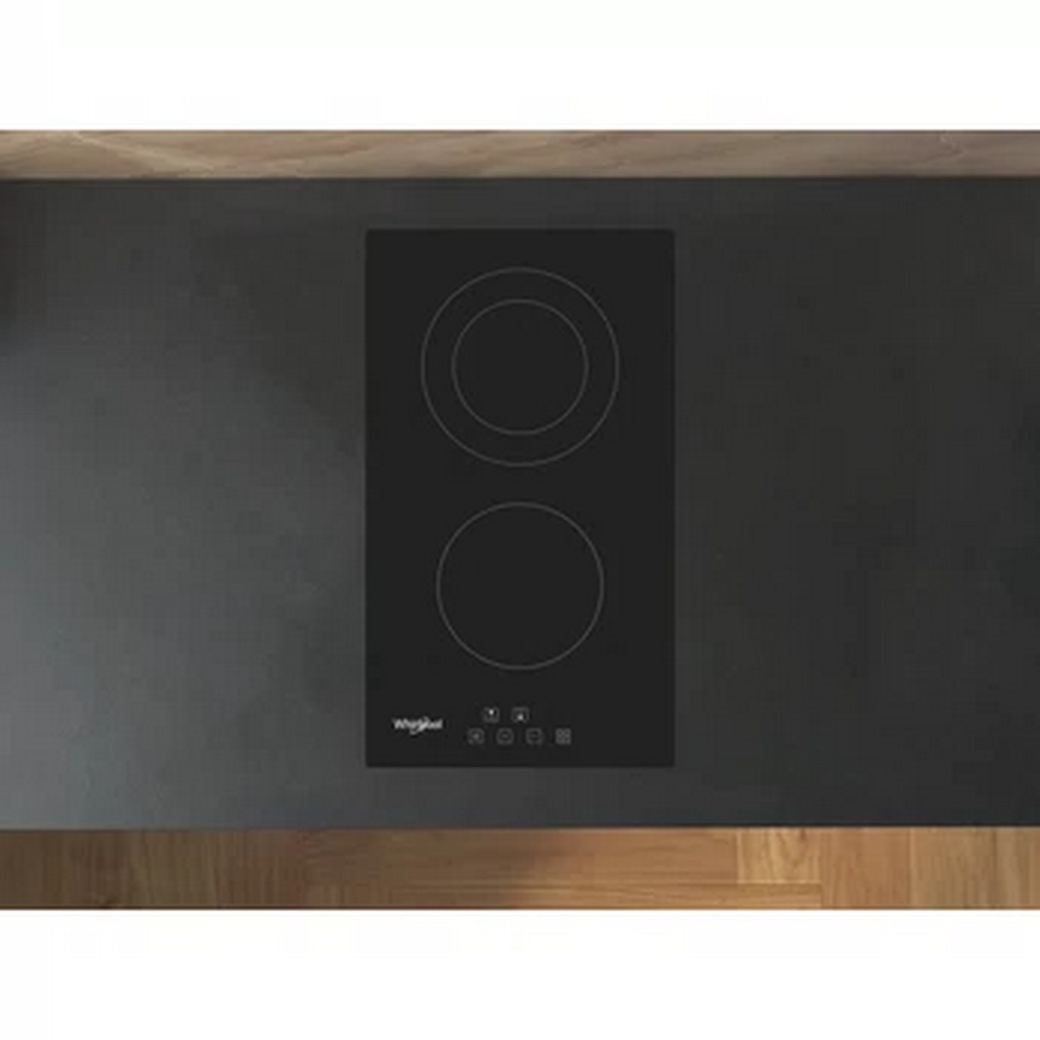Black induction cooktop with two circular burners, on a dark countertop.
