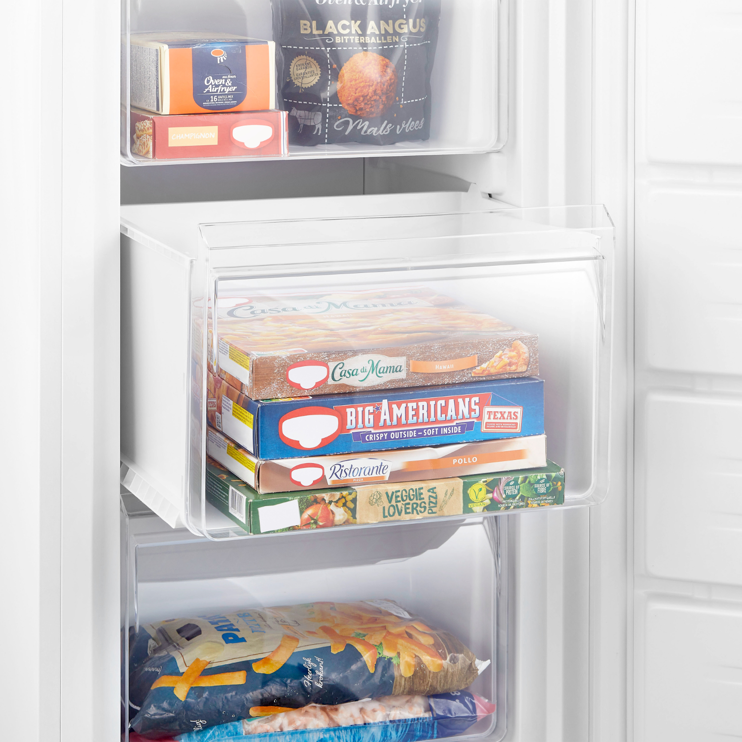 Freezer with frozen food boxes. Various boxes are visible inside a transparent drawer.