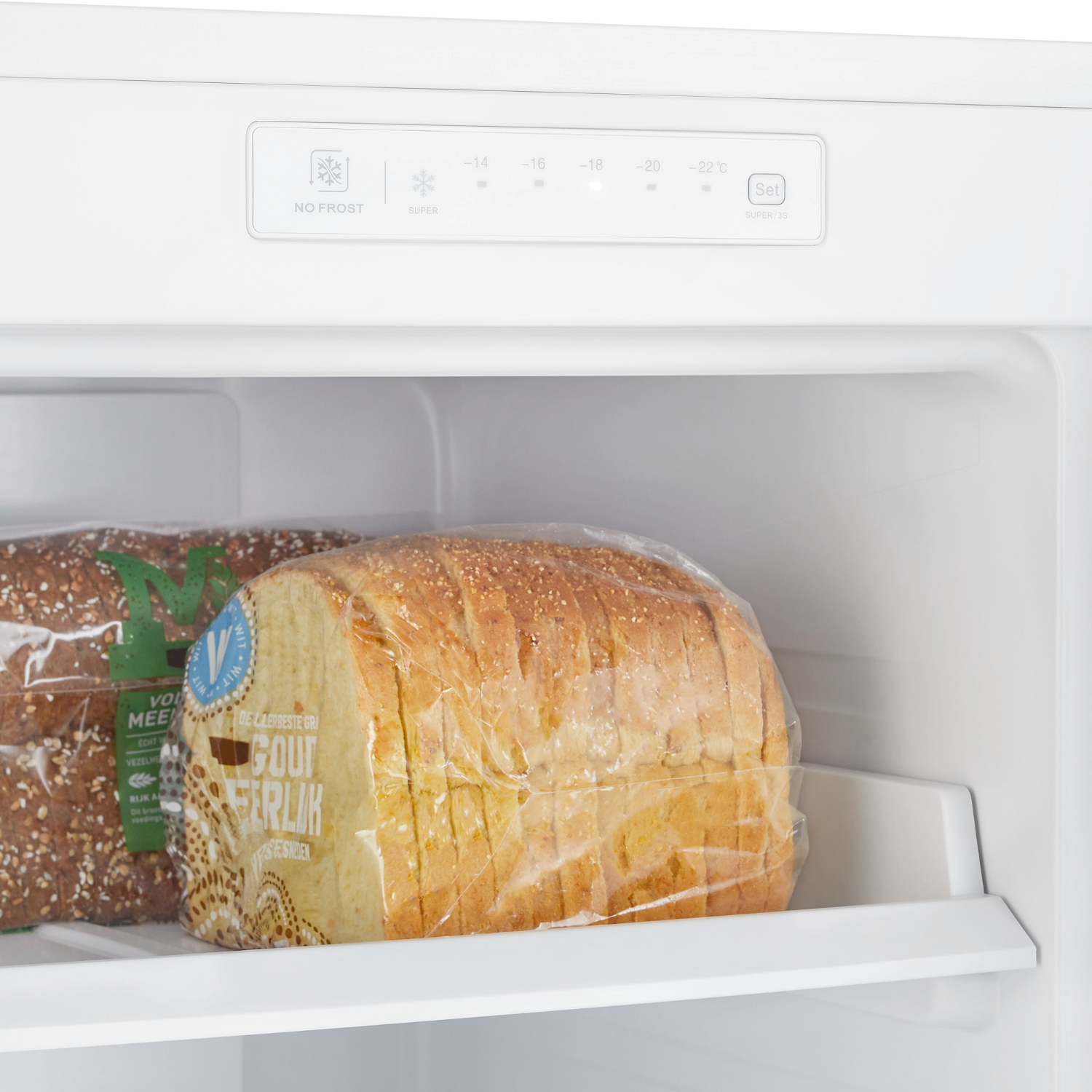A fridge interior with bread. There is a loaf of bread in a plastic bag.