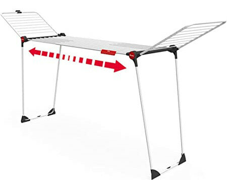 Biały i srebrny stojak do suszenia, z czerwonymi strzałkami pokazującymi rozkładanie na zewnątrz.