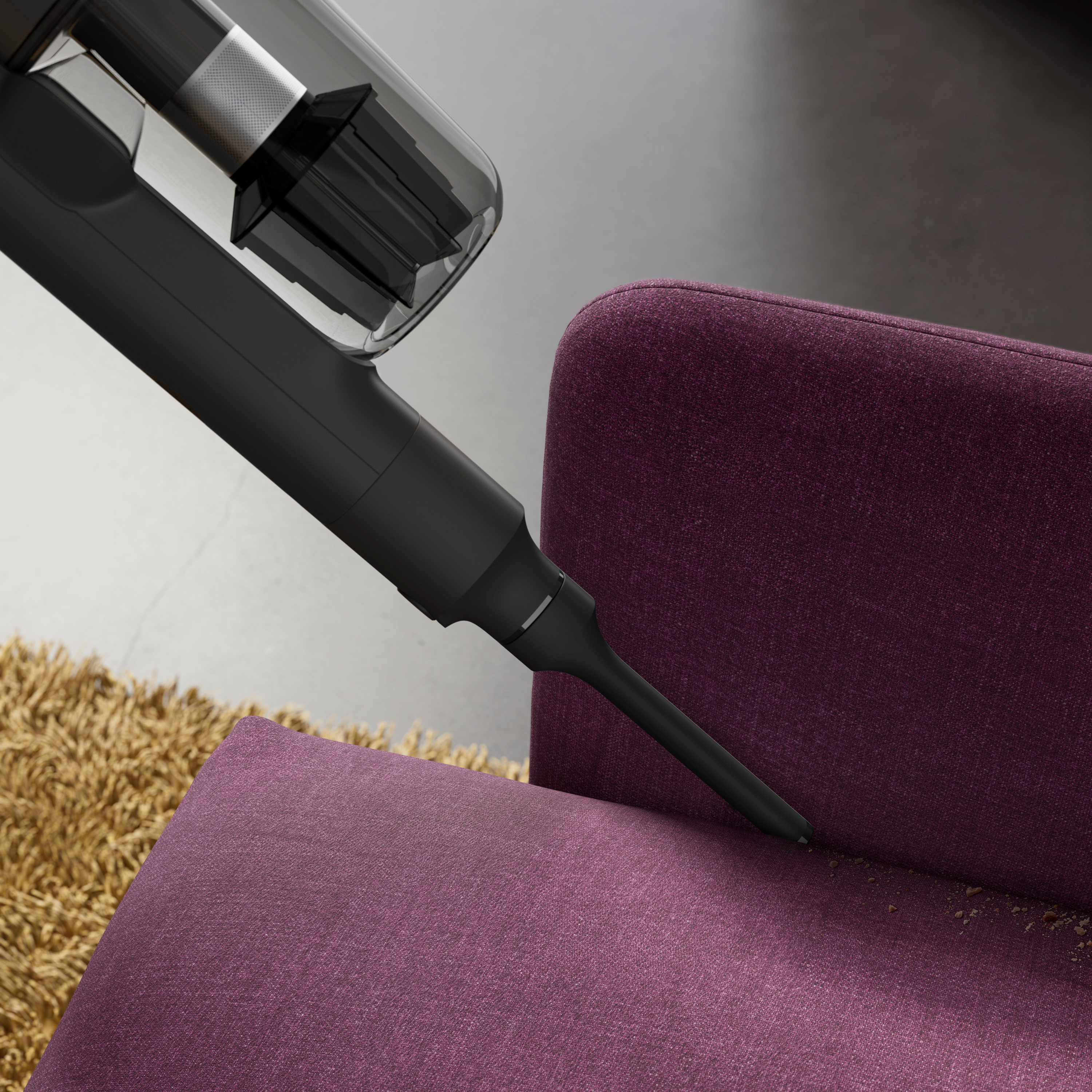 Vacuum cleaner cleaning a purple couch.