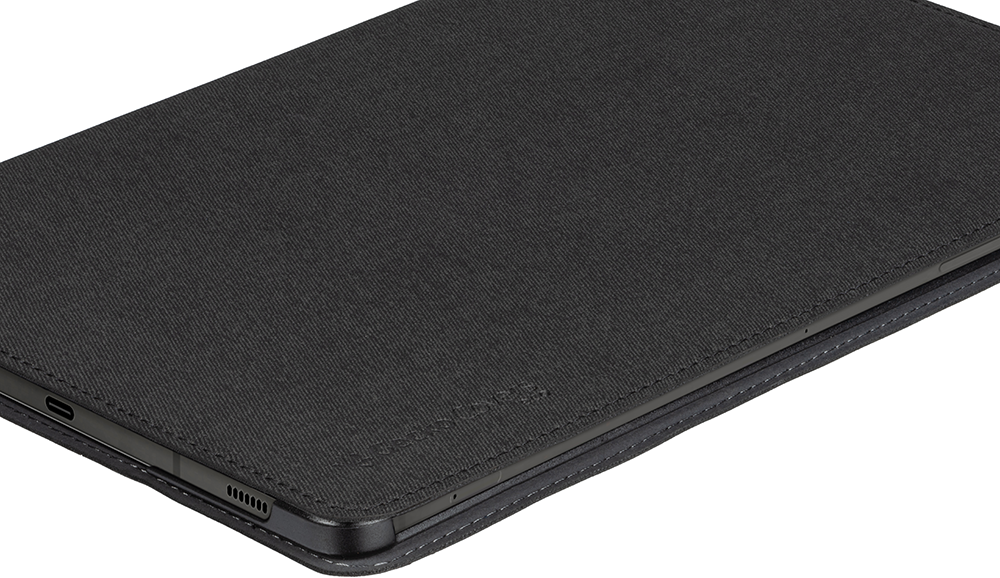 Black tablet case. The case is closed and made of fabric and leather. Close up.