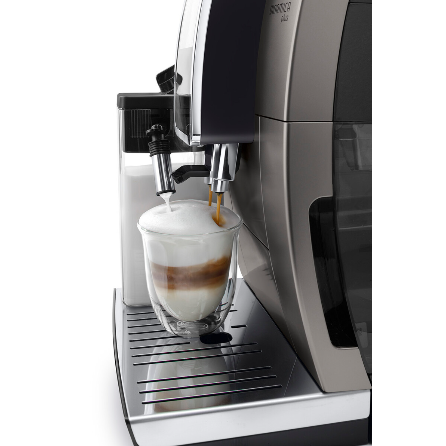 A coffee machine dispensing coffee into a glass with milk foam, white background.