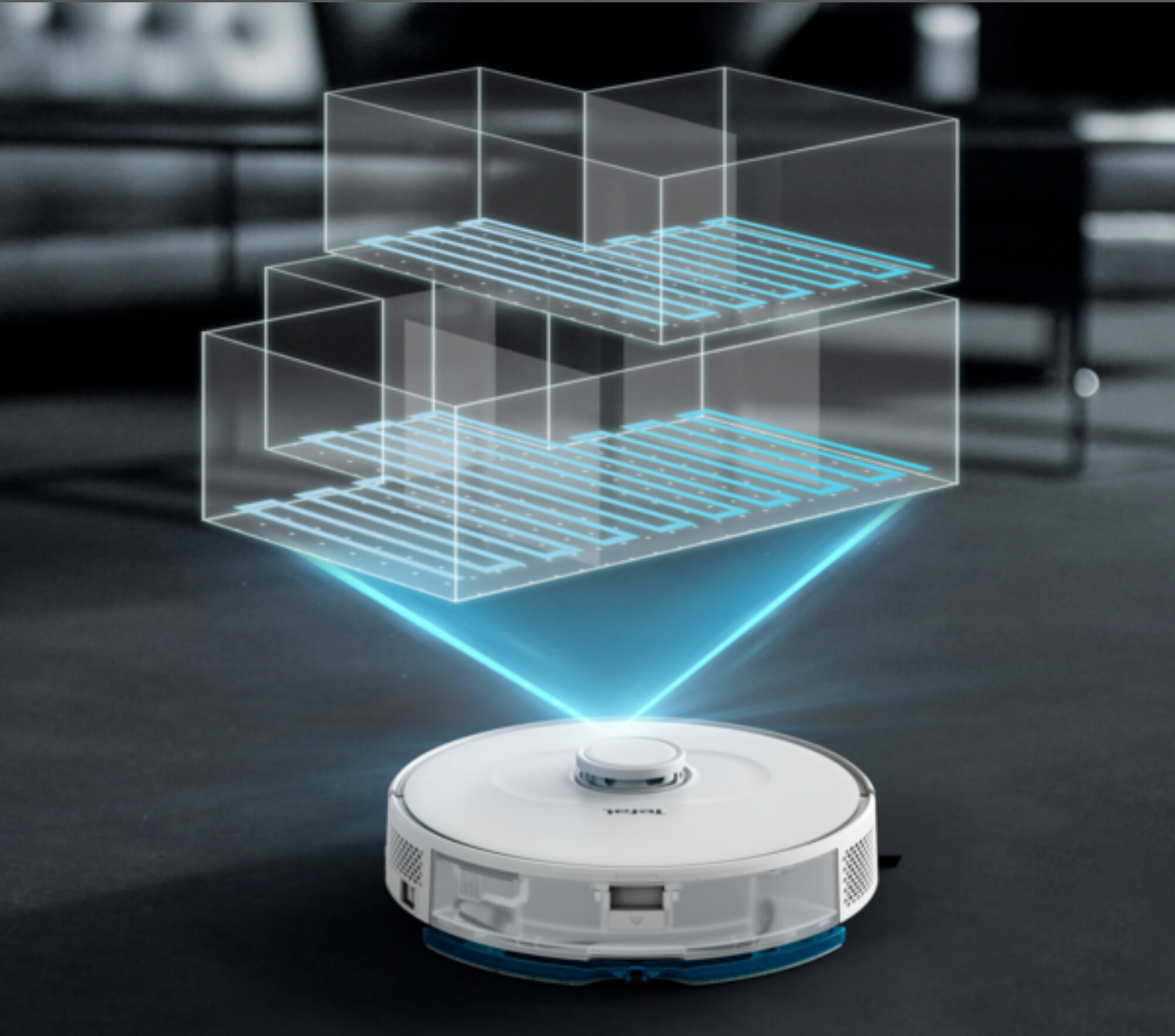 Robot sprzątający, z niebieską projekcją świetlną, pokazującą plan piętra z wirtualnymi pokojami.