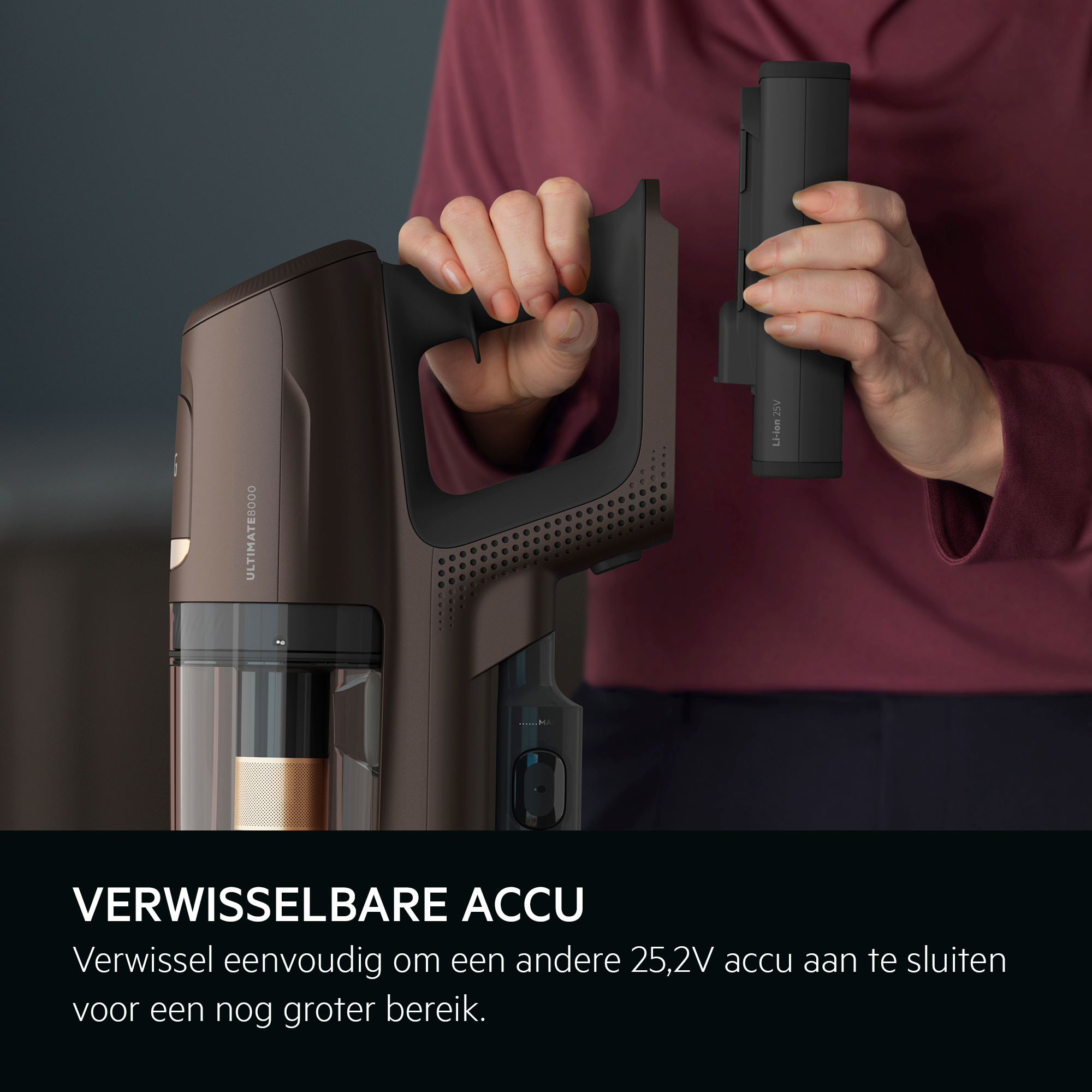 Person removing a 25.2V battery from a brown and black cordless vacuum.