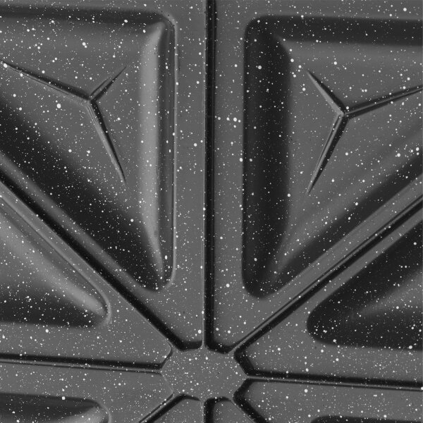 Zbliżenie czarnej granitowej powierzchni z białymi plamkami i geometrycznymi kształtami.