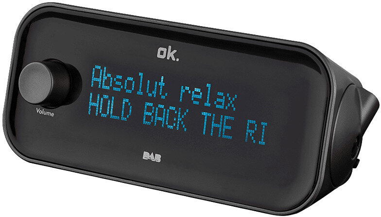 Czarna radio DAB wyświetla tekst 'Absolut relax HOLD BACK THE RI'. Pokrętło głośności jest po lewej.