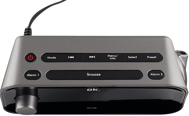 Szary i czarny cyfrowy budzik z przyciskami oznaczonymi 'Mode', 'Snooze' i 'Alarm'.