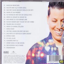 CD-Hülle mit Songtiteln und einem lächelnden Mann. Der Hintergrund zeigt ein verschwommenes, farbenfrohes Design.