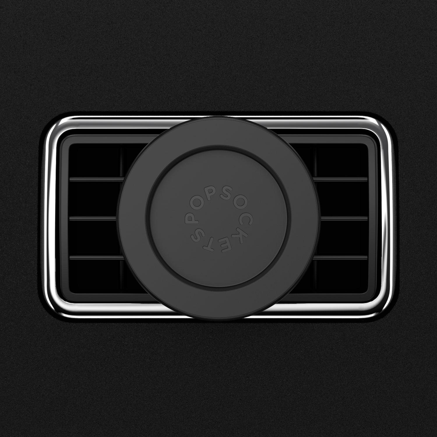 Schwarzer PopSockets-Handyhalter an einer Auto-Luftöffnung, mit Chromblende.