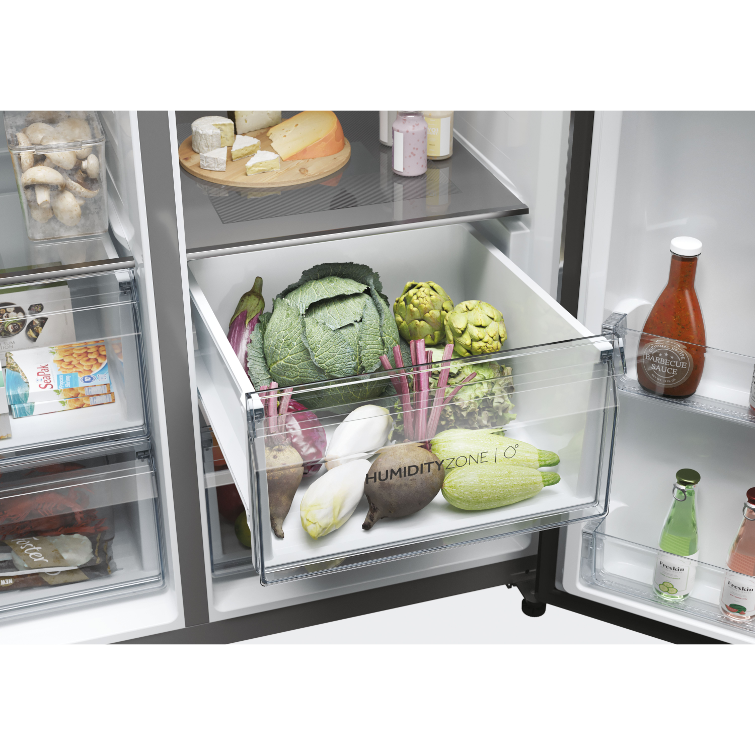Refrigerator open, vegetables, cheese, and food items inside, clear drawers.