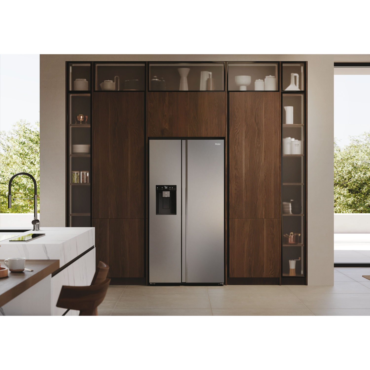 Kitchen with stainless steel refrigerator. Wooden cabinets and a marble countertop.