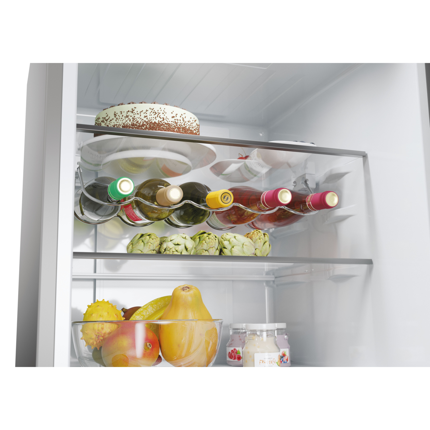 Inside a fridge: wine bottles, cake, artichokes, fruits, and jars.