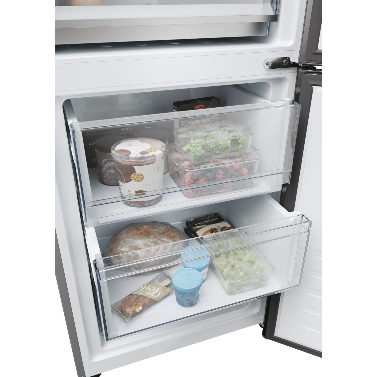 Refrigerator interior with drawers, showing food items and containers.